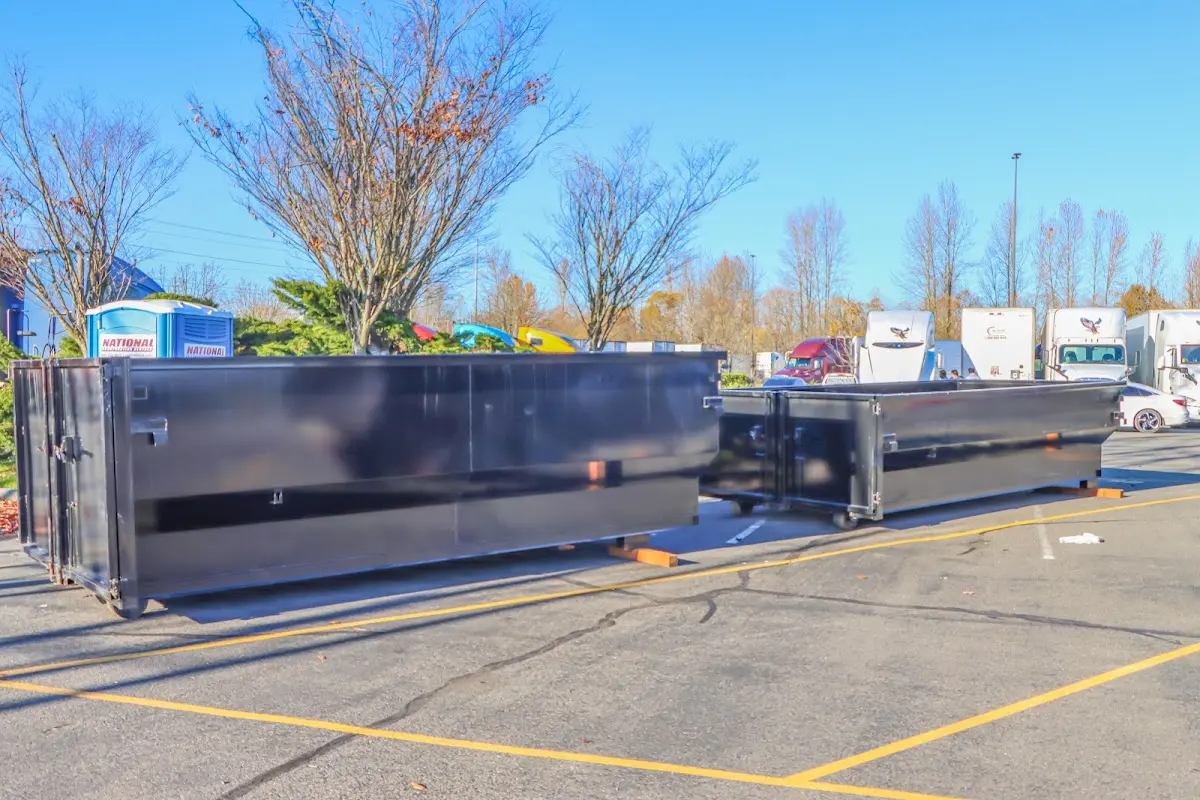 Professional dumpster rental service with roll-off container on residential driveway in Turlock